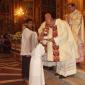 H2 Fr George Buttigieg gives  Holy Communion to his niece