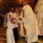 I4 Fr Charles Sultana gives Holy Communion to a relative