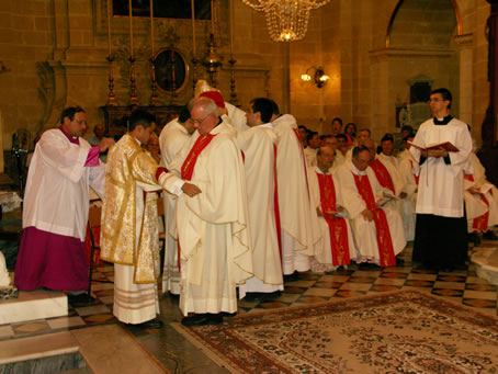 E4 Xaghra Archpriest puts the dalmatic on Deacon Farrugia