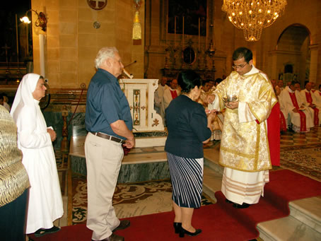 I2 Bishop's Parents recieve Holy Communion from Deacon Farrugia