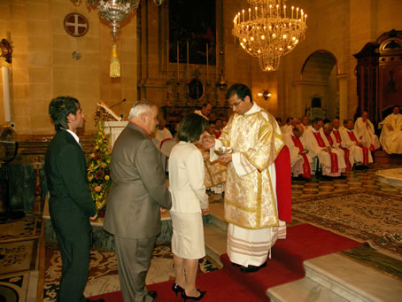 H9 Deacon Farrugia gives Holy Communion to his parents