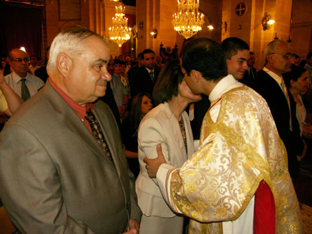 H6 Deacon Farrugia embraces his parents with the sign of peace