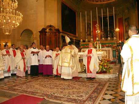 E9 Bishop embraces Deacon Joseph Curmi