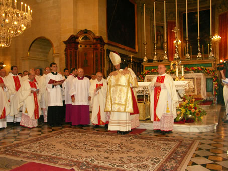 F1 Bishop embraces Deacon Richard Farrugia