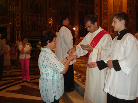 A9 Rev Richard Farrugia distributing Holy Communion