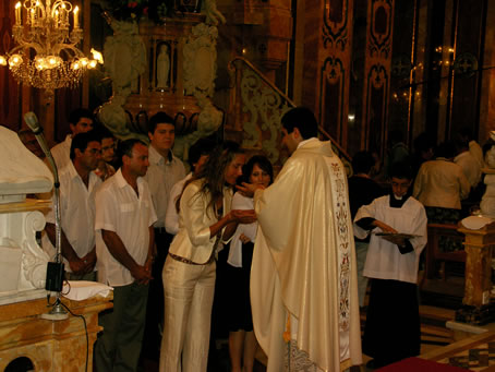 Q2 Kissing the new priest's hands