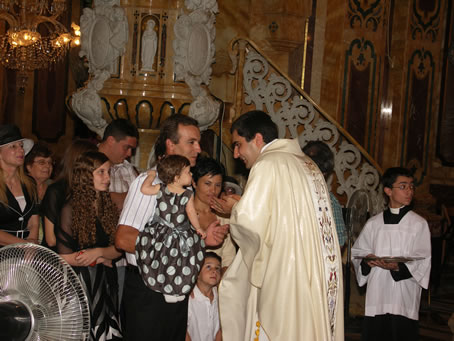 Q4 Kissing the new priest's hands