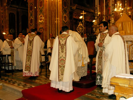 N2 Kissing the new priest's hands