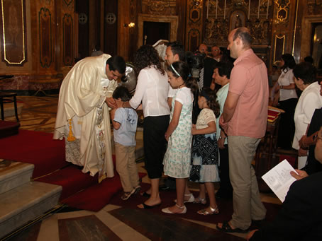 Q6 Kissing the new priest's hands