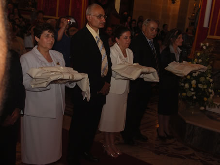 F4 Parents hold priests' vestments