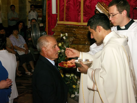 L5 Fr Bajada's father receives Holy Communion from his son