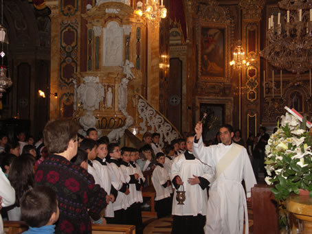 C1 Rev Deacon A Bajada sprinkles Holy Water on congregants