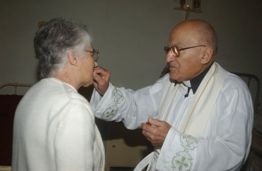 E8 Can G Farrugia administering Holy Communion