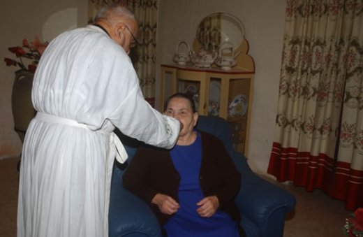 E6 Can Julian Refalo Rapa administering Holy Communion