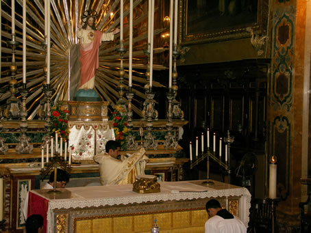 I8 Fr Anthony Bajada imparts Benediction with the Holy Eucharist