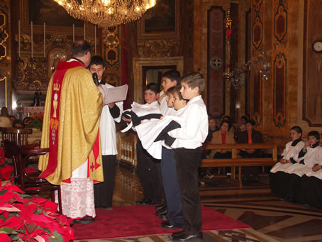 B9 Boys present the vestments