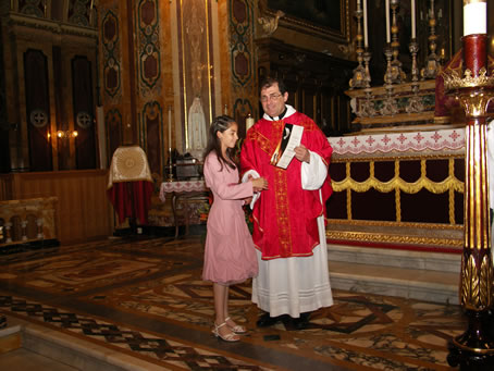 H2 Archpriest hands certificate of Confirmation