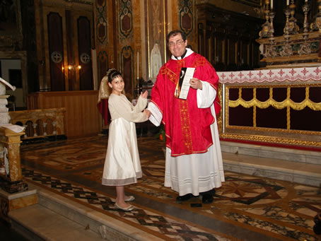 H1 Archpriest hands certificate of Confirmation