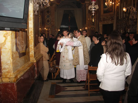 C2 Archpriest placing cloth underneath Baby Jesus