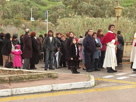 F1 Umbrellas folded faithful follow procession