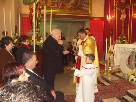 E4 Bishop's father receives Holy Communion