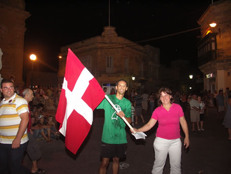 G1 John triumphantly holds the flag of the Order