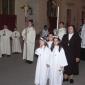 D6 Girls clad in white robes follow tha Blessed Sacrament