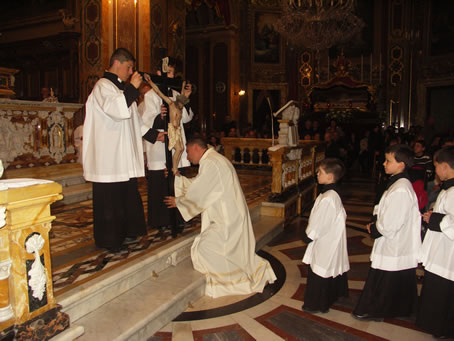 G1 Father Jesmond Gauci kisses the Cross