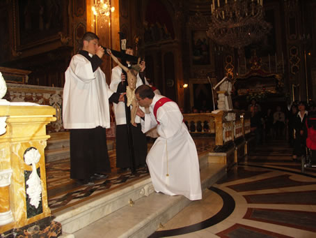 F3 Deacon Richard N Farrugia kisses the Cross