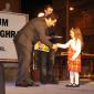 F5 Mayor presents books to a toddler