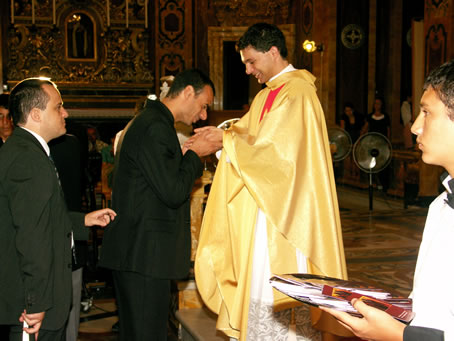 192 Local Councillor J Bartolo kissing Fr Caruana's hands