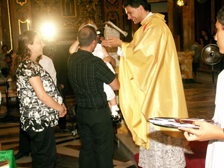 190 A young girl kissing Fr Caruana's hands