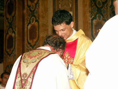 180 Priest kissing Fr Caruana's hands