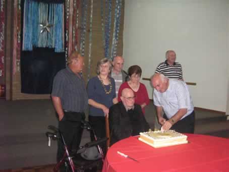 14 his nephew fixing the candles on the cake