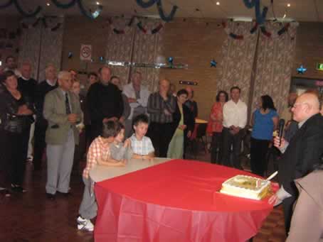 28 the young ones seem more attentive to the cake