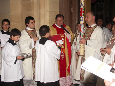 A4 Can John Sultana holding the Paschal Candle