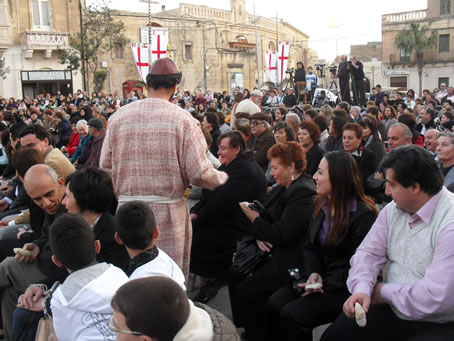 E8 Distributing bread to the hungry crowd