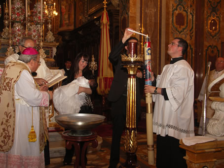 52 Baby's father Noel Galea lights a candle