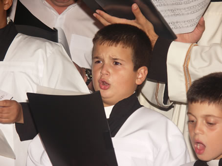 023 Young altar boy singing with the choir