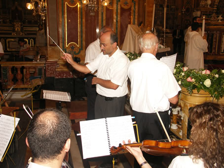 126 Mr Ronald Camilleri directing the orchestra and choir