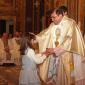 J2 Girl who will receive Holy Communion this year offers a candle