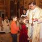 J1 Children who will receive Holy Communion this year offer a candle