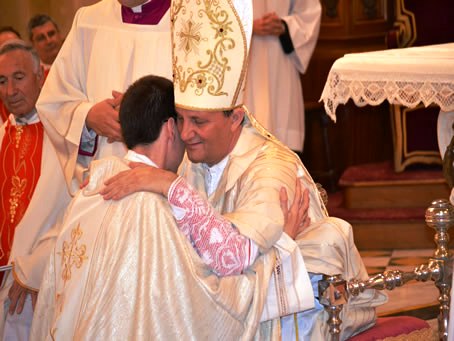 104 Bishop embraces new priest Fr Daniel Grech