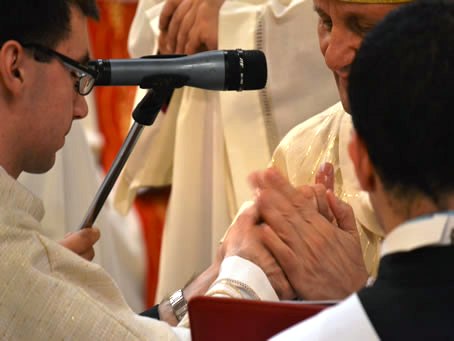 090 Bishop anointing Daniel's hands with Sacred Oils