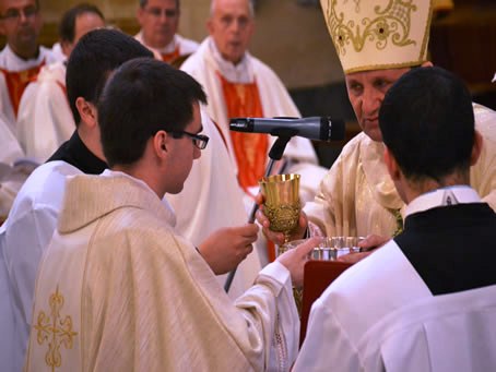 097 Bishop hands Chalice and Hosts to Fr Daniel