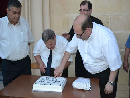 131 Fr Mark helps Frans Said cut the birthday cake