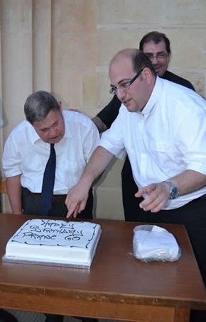 132 Fr Mark helps Frans Said cut the birthday cake