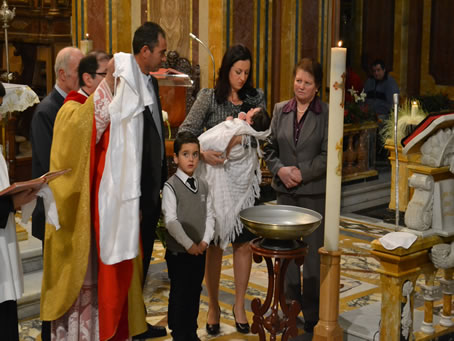 28 Celebrant exhibits white robe sign of purity