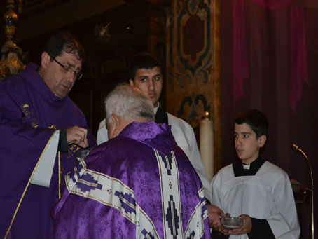 32 Placing ashes on priest's forehead