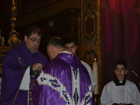 33 Placing ashes on priest's forehead